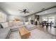 Open living space with sectional sofa, coffee table, and adjacent dining area at 8390 64Th N St, Pinellas Park, FL 33781