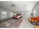 Main bedroom with king bed, ceiling fan and orange accent chairs at 8390 64Th N St, Pinellas Park, FL 33781