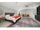 Main bedroom with large bed, ceiling fan, and view of private balcony at 8390 64Th N St, Pinellas Park, FL 33781