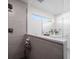Walk-in shower with gray tile, glass enclosure, and built-in shelves at 8390 64Th N St, Pinellas Park, FL 33781