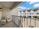 Private balcony overlooking courtyard with seating for two at 9901 1St E St # F, Treasure Island, FL 33706