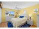 Sunny main bedroom features a view of the canal, ceiling fan, and white dresser and nightstands at 9901 1St E St # F, Treasure Island, FL 33706