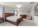 Spacious bedroom with large windows and wood furniture at 10675 Hawks Landing Dr, Land O Lakes, FL 34638