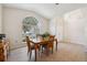 Dining area with a table and chairs near a large window at 11948 Palm Bay Ct, New Port Richey, FL 34654