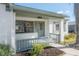 Quaint front porch with a light teal railing and door at 12939 116Th St, Largo, FL 33778