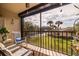 Peaceful screened balcony overlooking lush landscaping and palm trees at 1316 Pasadena S Ave # 203, South Pasadena, FL 33707