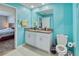 Bathroom with teal walls, double vanity, and walk-in shower at 15411 Miller Creek Dr, Sun City Center, FL 33573