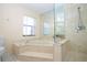 Bathroom features a corner soaking tub and walk-in shower at 1812 Wedge Ct, Sun City Center, FL 33573