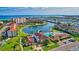 Aerial view of waterfront community with pool, dock, and lush landscaping at 19029 Us Highway 19 N # 7-28, Clearwater, FL 33764