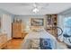 Cozy bedroom with built-in shelving, ceiling fan and hardwood floors at 19029 Us Highway 19 N # 7-28, Clearwater, FL 33764