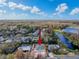 Aerial view of a single-Gathering home with a large backyard, situated near a lake at 19212 Sunlake Blvd, Lutz, FL 33558