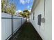 Side yard with a privacy fence and small lawn area at 19212 Sunlake Blvd, Lutz, FL 33558