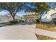 Two-story house with a two-car garage and a large driveway, viewed from across the street at 19538 Timberbluff Dr, Land O Lakes, FL 34638