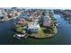 Aerial view of a waterfront home with a private dock, lush landscaping, and a sparkling swimming pool at 224 7Th E St, Tierra Verde, FL 33715