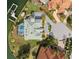 An aerial shot of the house shows the tile roof, screened pool, and lush landscaping at 224 7Th E St, Tierra Verde, FL 33715