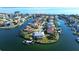 An aerial view of the house shows its location on a canal with water access and boat dock at 224 7Th E St, Tierra Verde, FL 33715