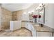 Elegant bathroom with double sinks, granite countertops, and a walk-in shower at 224 7Th E St, Tierra Verde, FL 33715