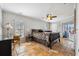 Bedroom features decorative tiled floor, dark wood furniture, a ceiling fan, and access to a screened in porch at 224 7Th E St, Tierra Verde, FL 33715