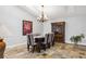 Formal dining area with stone floors, a chandelier, and a cabinet for elegant entertaining at 224 7Th E St, Tierra Verde, FL 33715