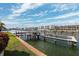 Dock showing wood beams, a boat lift, a ladder into the water, and views of the surrounding neighborhood at 224 7Th E St, Tierra Verde, FL 33715