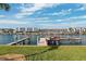 Dock showing wood beams, a boat lift, a ladder into the water, and views of the surrounding condos at 224 7Th E St, Tierra Verde, FL 33715