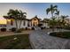 Beautiful exterior of the home at dusk, with lush landscaping and a welcoming entrance at 224 7Th E St, Tierra Verde, FL 33715