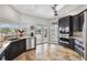 Well-lit kitchen featuring granite countertops, stainless steel appliances, and direct access to an outdoor seating area at 224 7Th E St, Tierra Verde, FL 33715