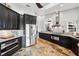 Modern kitchen with stainless steel appliances, dark cabinets, granite counters, and stone floors at 224 7Th E St, Tierra Verde, FL 33715