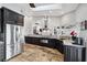 Modern kitchen with stainless steel appliances, granite countertops, and dark wood cabinets at 224 7Th E St, Tierra Verde, FL 33715