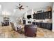 Spacious living room with stone floors, fireplace, wet bar, and views of the dining area at 224 7Th E St, Tierra Verde, FL 33715