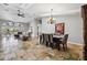 Bright open-concept living room with tile floors, dining area, and comfortable seating by large sliding glass doors at 224 7Th E St, Tierra Verde, FL 33715