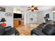 Inviting living room featuring a ceiling fan, tile floors, and access to a private study at 224 7Th E St, Tierra Verde, FL 33715