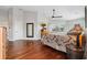 Airy primary bedroom features hardwood floors, neutral paint, ceiling fan, and sliding glass door to a patio at 224 7Th E St, Tierra Verde, FL 33715