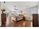 Spacious main bedroom with hardwood floors, ceiling fan, and access to a private patio at 224 7Th E St, Tierra Verde, FL 33715