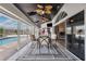 Relaxing covered patio with stylish seating, a bar, and direct access to the refreshing pool at 224 7Th E St, Tierra Verde, FL 33715