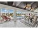 Outdoor patio with comfortable seating and dining area, offering beautiful views of the pool and community at 224 7Th E St, Tierra Verde, FL 33715