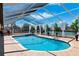 A beautiful, screened pool overlooks the canal, with plenty of space to relax at 224 7Th E St, Tierra Verde, FL 33715