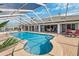 Beautiful waterfront pool with an integrated spa and ample brick patio space with chairs for lounging and dining at 224 7Th E St, Tierra Verde, FL 33715