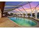 The screened pool at sunset offers a private and relaxing retreat with canal views at 224 7Th E St, Tierra Verde, FL 33715