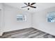 Well-lit bedroom featuring grey flooring and multiple windows at 2254 66Th S Ave, St Petersburg, FL 33712