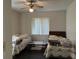 Bedroom with two twin beds and ceiling fan at 2416 Wishing Well Cir, Tampa, FL 33619