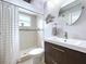 Bathroom with tiled shower, modern vanity, and circular mirror at 3004 Rosebud Ln, Brandon, FL 33511