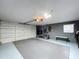 Spacious garage interior with white garage door and storage space at 3004 Rosebud Ln, Brandon, FL 33511