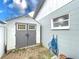 Storage shed with double doors, hose, and window at 3004 Rosebud Ln, Brandon, FL 33511