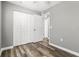 Bedroom with wood-look floors and double door closet at 316 W South Ave, Tampa, FL 33603