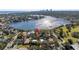 A high-angle aerial view showcasing the home's location near a body of water and a city skyline at 323 Coffee Pot Ne Dr, St Petersburg, FL 33704