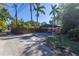 Backyard with a basketball hoop and wooden fence at 323 Coffee Pot Ne Dr, St Petersburg, FL 33704