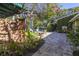 Private backyard retreat with a pool, lush landscaping, and decorative wall at 323 Coffee Pot Ne Dr, St Petersburg, FL 33704