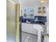 Bathroom with blue tile, white fixtures, and window offering waterfront view at 323 Coffee Pot Ne Dr, St Petersburg, FL 33704