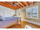 Bedroom with wooden floors, ceiling fan, large windows, and built-in closets at 323 Coffee Pot Ne Dr, St Petersburg, FL 33704